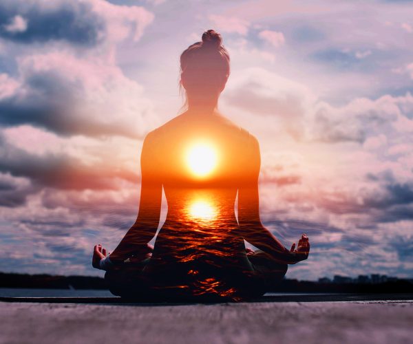 Yoga day concept. Multiple exposure image. Woman practicing lotus asana at sunset